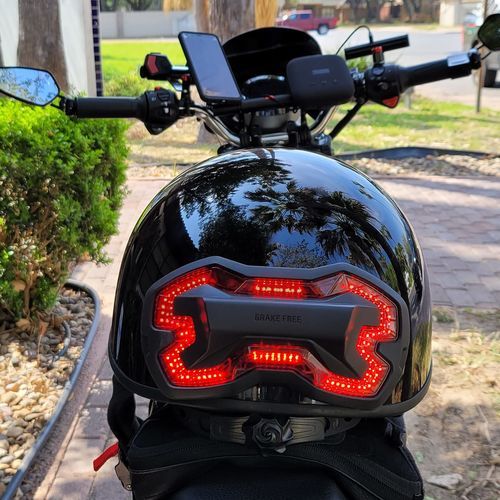 Brake Free smart helmet brake light on a half helmet for motorcyclist