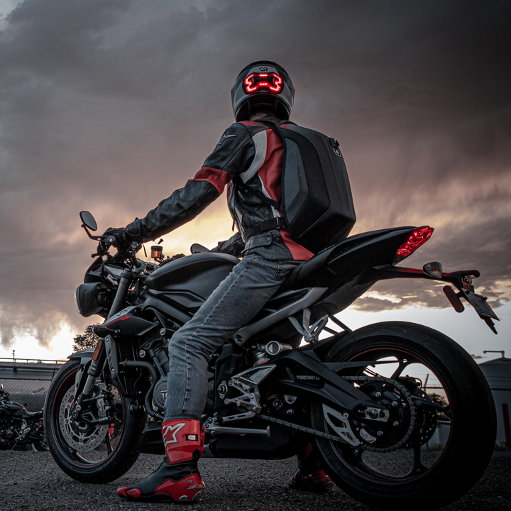 Lifestyle photo of Brake Free. Ride with confidence and style with Brake Free. Brake Free - an ultra-bright smart LED brake light that instantly improves rider's visibility. Simple installation, no wires. Smart brake light for your helmet. Be seen day and night. Ride in any weather. Long lasting rechargeable lithium ion battery.